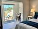 Serene bedroom with a private balcony and comfortable furnishings, promoting a relaxing atmosphere at 100 Bluff View Dr # 117C, Belleair Bluffs, FL 33770