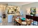 Inviting dining room area featuring an adjacent open kitchen with stainless steel appliances and a cozy breakfast bar at 100 Bluff View Dr # 117C, Belleair Bluffs, FL 33770