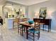Cozy dining room area with an open layout to the kitchen, with views of stainless steel appliances and modern lighting at 100 Bluff View Dr # 117C, Belleair Bluffs, FL 33770