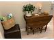 Hallway with a drop leaf table with decorations, a dark ottoman, and beach bag at 100 Bluff View Dr # 117C, Belleair Bluffs, FL 33770