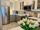 Bright kitchen showcasing stainless steel appliances and stylish cabinets, and countertops at 100 Bluff View Dr # 117C, Belleair Bluffs, FL 33770