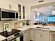 Well-equipped kitchen features sleek stainless steel appliances, modern cabinetry, and quartz countertops at 100 Bluff View Dr # 117C, Belleair Bluffs, FL 33770