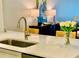 Kitchen with counter seating, stainless steel faucet, and white countertops at 100 Bluff View Dr # 117C, Belleair Bluffs, FL 33770