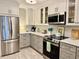Modern kitchen featuring stainless steel appliances, stylish cabinets, and countertops at 100 Bluff View Dr # 117C, Belleair Bluffs, FL 33770