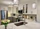 Modern kitchen with white cabinets, stainless steel appliances, quartz countertops, and stylish lighting fixtures at 100 Bluff View Dr # 117C, Belleair Bluffs, FL 33770