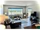 Bright and airy living room with natural light, neutral tones, and comfortable seating arrangements at 100 Bluff View Dr # 117C, Belleair Bluffs, FL 33770