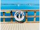 Harbour Club pier features benches and a life preserver showcasing the waterfront and recreational amenities of the property at 100 Bluff View Dr # 117C, Belleair Bluffs, FL 33770