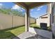 Private backyard featuring a paver patio and a well-maintained lawn, perfect for outdoor relaxation at 1018 Rose Blossom Ct, Tampa, FL 33613