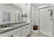 Bathroom featuring double sinks, granite countertops, and glass shower with tiled walls at 1018 Rose Blossom Ct, Tampa, FL 33613