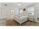 Bright bedroom featuring a white bed, neutral linens, and ensuite bathroom access at 1018 Rose Blossom Ct, Tampa, FL 33613