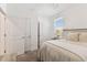 Bedroom with ensuite bath, closet, neutral linens, and natural light at 1018 Rose Blossom Ct, Tampa, FL 33613