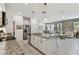 Modern kitchen with granite countertops, stainless steel appliances, and an island that opens to the living area at 1018 Rose Blossom Ct, Tampa, FL 33613