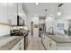 Kitchen with white cabinetry, stainless steel appliances, and granite countertops at 1018 Rose Blossom Ct, Tampa, FL 33613