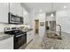 Bright kitchen with stainless steel appliances, granite countertops, and a subway tile backsplash at 1018 Rose Blossom Ct, Tampa, FL 33613