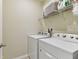 Laundry room equipped with a Whirlpool washer and dryer set at 1018 Rose Blossom Ct, Tampa, FL 33613