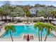 Resort-style pool area with palm trees, lounge chairs, and stylish seating, ideal for relaxing in a tropical atmosphere at 1018 Rose Blossom Ct, Tampa, FL 33613