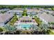 A beautiful community pool is surrounded by tropical landscaping and residences at 1018 Rose Blossom Ct, Tampa, FL 33613