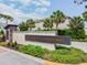 Community sign featuring the neighborhood name, 'Bearss Landing', with palm trees and landscaping at 1018 Rose Blossom Ct, Tampa, FL 33613