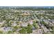 Wide aerial shot of a green residential area near baseball fields with views of a city in the distance at 1104 S Lois Ave, Tampa, FL 33629