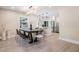 Bright dining area features an elegant chandelier, and an open floorplan extending into the kitchen at 1104 S Lois Ave, Tampa, FL 33629