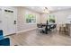 Bright dining area with chandelier lighting, modern furniture, and large windows at 1104 S Lois Ave, Tampa, FL 33629
