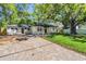 Charming home with a well-manicured lawn and a beautiful, mature tree in the front yard at 1104 S Lois Ave, Tampa, FL 33629
