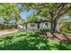 Charming house with mature trees offering shade in the front yard at 1104 S Lois Ave, Tampa, FL 33629