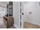 Hallway with a wooden console table and black and white artwork, leading to a laundry room at 1104 S Lois Ave, Tampa, FL 33629