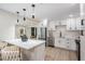Modern kitchen with quartz countertops, stainless steel appliances, island with seating, and pendant lighting at 1104 S Lois Ave, Tampa, FL 33629