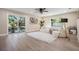 Bright living room with a large sliding glass door and a cozy white sofa at 1104 S Lois Ave, Tampa, FL 33629