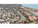 Expansive aerial view displays the waterfront community with a canal leading to the ocean and beach at 11525 Gulf Blvd # 401, Treasure Island, FL 33706