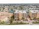 Aerial view showing condo buildings, lush landscaping, boat docks and surrounding waterways at 11525 Gulf Blvd # 401, Treasure Island, FL 33706