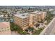 Aerial view of condo buildings, landscaping, and nearby waterways showing the coastal community at 11525 Gulf Blvd # 401, Treasure Island, FL 33706