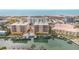 A high-angle shot shows residences, a pool and boat docks with ocean and beach in background at 11525 Gulf Blvd # 401, Treasure Island, FL 33706