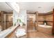 Bathroom featuring large vanity, granite countertops, glass enclosed shower, and soaking tub at 11525 Gulf Blvd # 401, Treasure Island, FL 33706