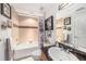 Bathroom featuring a shower and tub combination, framed art, and vanity with countertop sink at 11525 Gulf Blvd # 401, Treasure Island, FL 33706