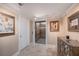 Clean elevator entrance with tile floors, wall art and mirrored side table at 11525 Gulf Blvd # 401, Treasure Island, FL 33706