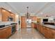 Well-equipped kitchen with wooden cabinetry, stainless steel appliances, and granite countertops at 11525 Gulf Blvd # 401, Treasure Island, FL 33706