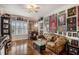 Living room featuring hardwood floors, vintage decor, and window with white shutters at 11525 Gulf Blvd # 401, Treasure Island, FL 33706