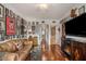 Open concept living room featuring hardwood floors, vintage decor, fireplace, and access to hallway at 11525 Gulf Blvd # 401, Treasure Island, FL 33706