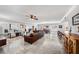 Spacious living room with a leather sofa, marble floors, and plenty of natural light at 11525 Gulf Blvd # 401, Treasure Island, FL 33706