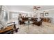 Inviting living room featuring a plush sofa, stylish furnishings, and light-filled windows at 11525 Gulf Blvd # 401, Treasure Island, FL 33706