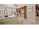 Bright living room featuring custom bookshelves, a sofa, and balcony access at 11525 Gulf Blvd # 401, Treasure Island, FL 33706