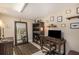Well-lit home office featuring a dark wood desk, shelving and a decorative collection at 11525 Gulf Blvd # 401, Treasure Island, FL 33706