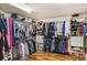 Spacious walk-in closet with built-in shelving, multiple rods, and laminate floors at 11525 Gulf Blvd # 401, Treasure Island, FL 33706