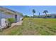Serene backyard featuring a small patio and well-maintained lawn at 124 Gloucester Blvd # 355J, Sun City Center, FL 33573