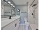 Modern bathroom featuring a double sink vanity and a sleek walk-in shower with black hardware at 124 Gloucester Blvd # 355J, Sun City Center, FL 33573