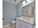 Bathroom featuring blue walls, white vanity with modern fixtures, and tiled flooring at 124 Gloucester Blvd # 355J, Sun City Center, FL 33573