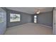 Bedroom featuring gray walls, neutral carpet, a ceiling fan, and windows with mini-blinds at 124 Gloucester Blvd # 355J, Sun City Center, FL 33573