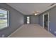 Empty room with neutral paint, carpet, ceiling fan, and two windows with blinds at 124 Gloucester Blvd # 355J, Sun City Center, FL 33573
